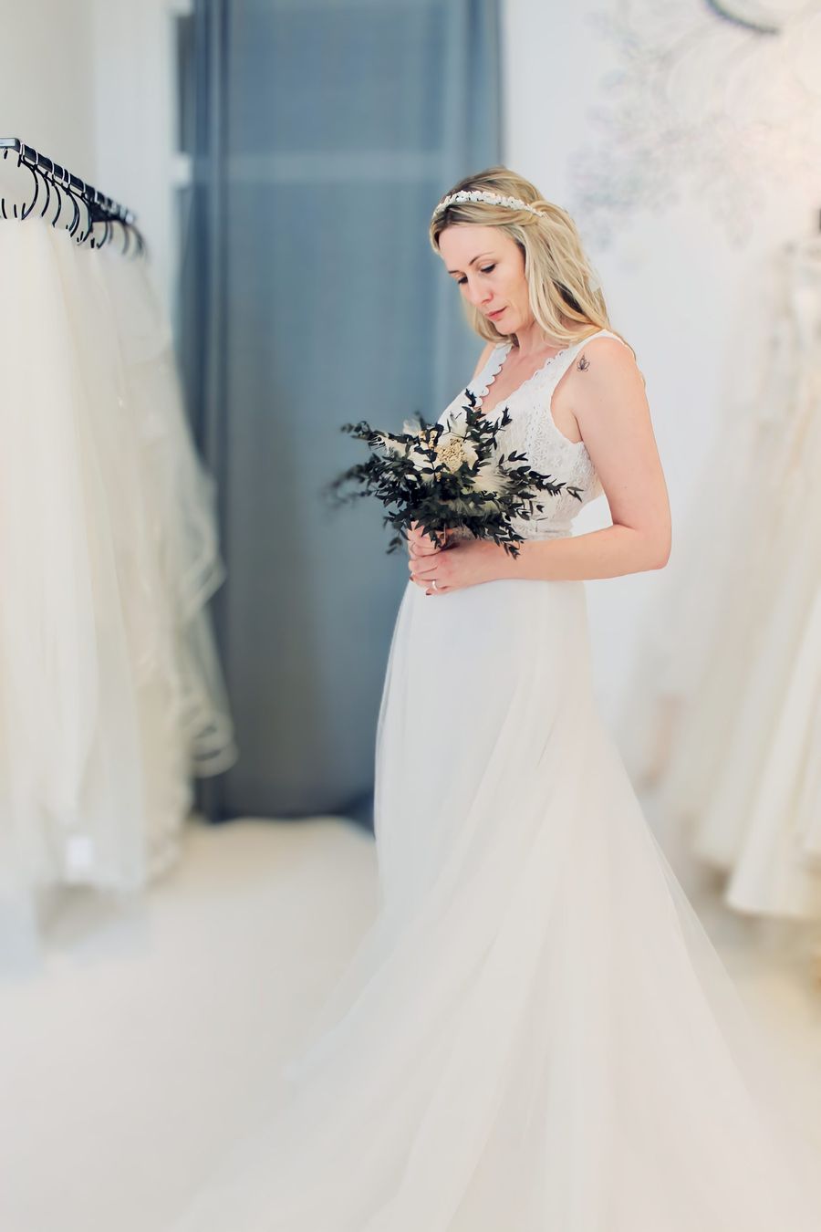 Second Hand Brautkleid Braut in der Anprobe mit Brautstrauß in einem Second Hand Brautkleid